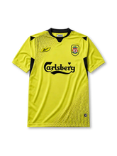 Liverpool 2004-05 away jersey, front view, yellow body with black honeycomb pattern, black V-neck collar, Reebok logo, club crest, Carlsberg sponsor logo