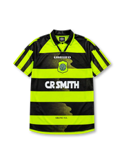Celtic 1996-97 away jersey, front view, neon-yellow and black hooped design, black polo-style collar, diagonal striped raglan sleeves, white Umbro logo, Celtic shield crest with shamrock, white CR Smith sponsor logo, Celtic F.C. text near hem