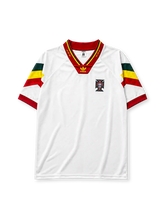 Portugal 1992-94 away jersey, front view, white body with green yellow and red chevron sleeves, red V-neck collar with gold script trim, adidas trefoil logo, Portuguese Football Federation crest