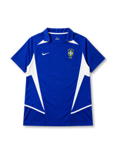 Brazil 2002 away jersey, front view, blue body with white angular side panels, point collar, Nike swoosh logo, CBF crest with four stars, Brasil text