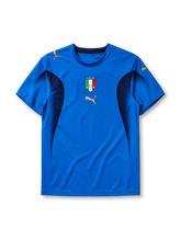 Italy 2006 home jersey, front view, blue body with navy side panels, crew neck collar, gold Puma logos, Italia crest with two stars