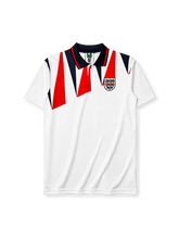 England 1992 home jersey, front view, white body with red and navy jagged triangle pattern, navy polo-style collar with red stripe trim, Three Lions crest with roses, small red logo mark near right shoulder