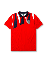 England 1992 away jersey, front view, red body with navy and white jagged triangle pattern, navy polo-style collar with red and white stripe trim, Three Lions crest with roses, small navy logo mark near right shoulder