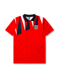 England 1992 away jersey, front view, red body with navy and white jagged triangle pattern, navy polo-style collar with red and white stripe trim, Three Lions crest with roses, small navy logo mark near right shoulder
