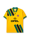 Bayern Munich 1993-95 away jersey, front view, golden yellow body with diagonal green and black stripe panels, green V-neck collar with black piping, black adidas Equipment logo, FC Bayern Munchen crest, black Opel sponsor logo, striped cuffs