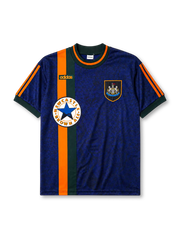 Newcastle United 1997-98 away jersey, front view, mottled navy body with orange and green vertical center stripe, dark green crew-neck collar with orange trim, green adidas logo, Newcastle United shield crest, circular Newcastle Brown Ale star sponsor badge