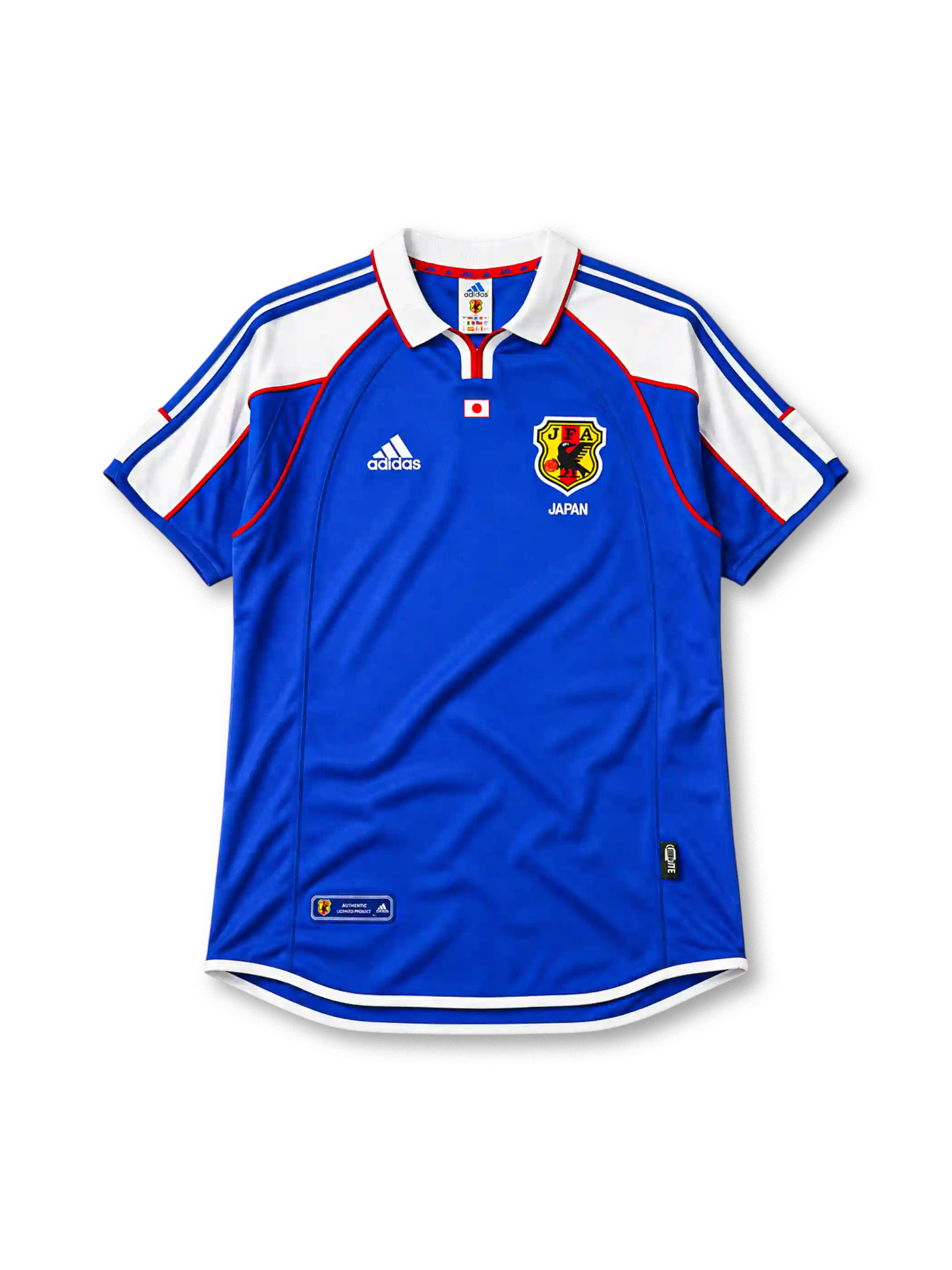 Japan 2000 home jersey, front view, blue body with white shoulder panels and red trim, white polo-style collar with red zip placket, small Japan flag emblem, JFA crest with three-legged crow, Japan text beneath crest
