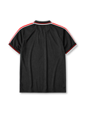 Manchester United 1998-99 third jersey, front view, black body, black white and red diamond pattern shoulder trim, black polo-style collar with zip placket, white Umbro logo, Manchester United devil crest, white Sharp sponsor logo
