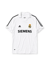 Real Madrid 2005-06 home jersey, front view, white body with black adidas three-stripe shoulder detailing, point collar, adidas logo, club crest, Siemens sponsor logo