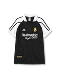 Real Madrid 2001-02 away jersey, front view, black body with white raglan sleeves, white polo-style collar, black adidas logo and stripes, Real Madrid crest with crown, white Realmadrid.com sponsor logo