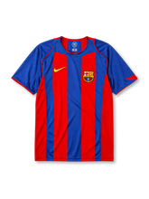 Barcelona 2004-05 home jersey, front view, bold blue and garnet vertical stripes, blue crew-neck collar with red trim, yellow Nike swoosh, Barcelona crest, no shirt sponsor