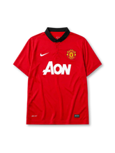 Manchester United 2013-14 home jersey, front view, red body, black polo-style collar with button placket, white Nike swoosh, Manchester United crest, white AON sponsor logo