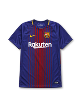 Barcelona 2017-18 home jersey, front view, fine blue and garnet vertical pinstripes, yellow-trimmed crew-neck collar, yellow Nike swoosh, Barcelona crest, white Rakuten sponsor logo