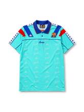 Barcelona 1992-95 away jersey, front view, mint turquoise body with repeated Barca script pattern, blue polo-style collar, red and blue diagonal shoulder panels, Kappa logo, Barcelona crest, blue Barca script wordmark