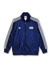 adidas x Oasis Firebird track top navy front view with white three stripes, trefoil logo, and oasis wordmark patch