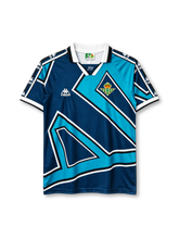 Real Betis 1995-97 away jersey, front view, navy and teal geometric pattern, white V-neck collar, Kappa logo and sleeve branding, club crest