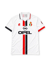 AC Milan 1996-97 away jersey, front view, white body with central red and black stripe, striped collar, Lotto logo, Opel sponsor logo, Scudetto shield