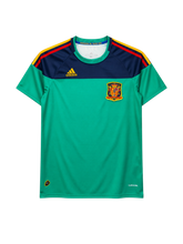 Spain 2010 World Cup goalkeeper jersey, front view, green body with navy yoke, red and yellow sleeve stripes, adidas logo, Spanish federation crest, Campeones del Mundo 2010 collar tape