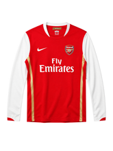 Arsenal 2006-07 long-sleeve home jersey, front view, red body with white sleeves, gold pinstripes, Nike swoosh, Fly Emirates sponsor logo, club crest, Emirates Stadium collar tag