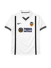 Valencia 2000-01 home jersey, front view, white body with black vertical stripes, Nike swoosh, Terra Mitica sponsor logo, club crest