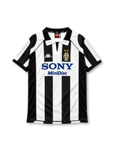 Juventus 1997-98 home jersey, front view, black and white vertical stripes, black polo collar with white tips and V-notch, Kappa logo on right chest, oval Juventus crest with two gold stars on left chest, navy SONY MiniDisc sponsor logo on white chest band, black mesh side panels, black cuffs
