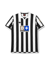 Juventus 1998-99 home jersey, front view, black and white vertical stripes, white polo collar with black V insert, Kappa logo on right chest, D+ Liberta Digitale sponsor logo with taupe and blue panels, Juventus crest patch on left sleeve, white cuffs with black trim