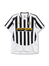 Juventus 2003-04 home jersey, front view, black and white vertical stripes, round crew neck with black and white trim, gold Nike swoosh on right chest, oval Juventus crest with two gold stars on left chest, yellow FASTWEB sponsor logo on black band, plain white lower body panel, white cuffs