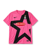 Juventus 2011-12 away jersey, front view, bright pink body, oversized black star graphic across front, pink crew neck collar, black Nike swoosh on right chest, oval Juventus crest with two gold stars on left chest, red BALOCCO oval sponsor logo, Nike Authentic tag at hem