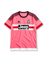 Juventus 2015-16 away jersey, front view, pink body, black crew neck collar, black three stripes on shoulders, red cuffs, black adidas logo on right chest, Juventus crest with three gold stars on left chest, white and red chest band with black JEEP sponsor panel, white hem band