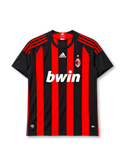 AC Milan 2008-09 home jersey, front view, red and black vertical stripes, black crew neck collar, black sleeves with red three stripes on shoulders, white adidas logo centred on chest, AC Milan crest with gold star on left chest, white BWIN sponsor logo, CLIMACOOL badge at hem