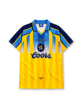 Chelsea 1995-96 away jersey, front view, yellow body with tonal vertical stripes, light blue gradient upper chest panel, navy raglan sleeves with light blue and yellow shoulder bands, light blue polo collar, navy UMBRO wordmark and circular lion crest centred on chest, navy COORS sponsor logo, CHELSEA F.C. text at hem