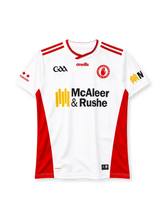 Tyrone 2024 home jersey, front view, white body, red crossover V-neck collar, red stripes on shoulders, red side panels, GAA logo on right chest, O'Neills wordmark centred, Tyrone red hand county crest on left chest, McAleer & Rushe sponsor logo, red stars on right sleeve, KOOLITE print at hem