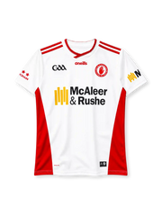 Tyrone 2024 home jersey, front view, white body, red crossover V-neck collar, red stripes on shoulders, red side panels, GAA logo on right chest, O'Neills wordmark centred, Tyrone red hand county crest on left chest, McAleer & Rushe sponsor logo, red stars on right sleeve, KOOLITE print at hem