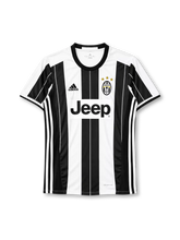 Juventus 2016-17 home jersey, front view, black and white vertical stripes with fine pinstripes, black crew neck collar, black side panels with three white stripes, black adidas logo on right chest, oval Juventus crest with three gold stars on left chest, black JEEP lettering on white chest panel, climacool print at hem