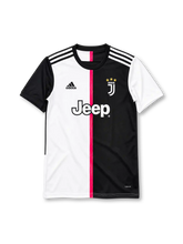 Juventus 2019-20 home jersey, front view, half white and half black split front with pink central stripe, black crew neck collar, contrasting black and white sleeves with three stripes on shoulders, black adidas logo on right chest, J monogram crest with three gold stars on left chest, white JEEP sponsor lettering