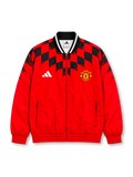 Manchester United 2026/27 red and black adidas Stadium track jacket featuring bold geometric checkerboard graphics, a white adidas logo, full-colour club crest, stand-up collar, and full-length front zipper.