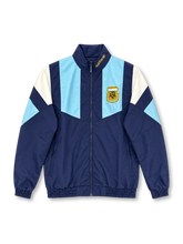 Front view of the Argentina 2026 adidas Originals EQT track jacket in navy blue with sky-blue chest panels, white geometric shoulder inserts, a gold AFA crest, gold adidas collar branding, full-length zipper, and elasticated cuffs.