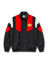 Front view of the Manchester United adidas Originals EQT track jacket in black with red chest panels, white and red geometric sleeve accents, club crest, white adidas Trefoil collar branding, full-length zipper, zippered pockets, and elasticated cuffs.