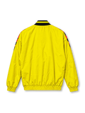 Front view of the adidas Club América 2026/27 Stadium Track Top in bright yellow, featuring a red and black geometric graphic across the shoulders and chest, black adidas performance logo, Club América crest, contrasting V-neck collar, full-length zipper, and zippered front pockets.