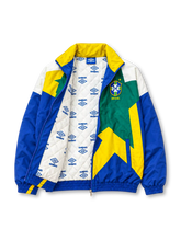 Front view of the Brazil 1993-94 Umbro national team track jacket featuring a large geometric star graphic in yellow and green, royal blue sleeves, white shoulder panels, an embroidered CBF crest, Umbro logo, full zip closure, and elasticated cuffs and hem.