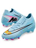 Nike Mercurial FG soccer cleats in light blue with multicolor confetti speckles, a black-outlined silver Swoosh, an orange painted toe graphic, an oversized M heel logo, and pink-tipped studs, shown as a pair.