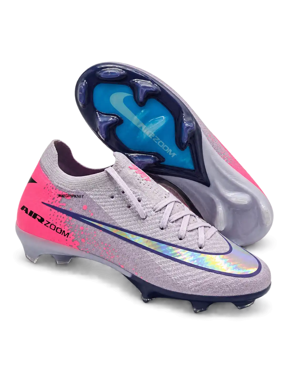 Nike Mercurial FG soccer cleats in lilac with a pink heel panel, pink paint-splatter accents, a navy-outlined holographic Swoosh, and Air Zoom heel lettering, plus a navy soleplate with a blue Air Zoom window, shown from the lateral side and outsole.