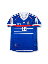 Front view of France 1998 World Cup home shirt in blue with white chest stripes, red chest band, tournament print, and number 10 on the front.