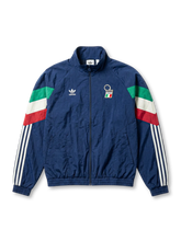 Italy national team adidas Originals 1994 retro track jacket in navy with tricolor flag sleeve panels, FIGC crest at chest, Trefoil logo, and Three Stripes on sleeves
