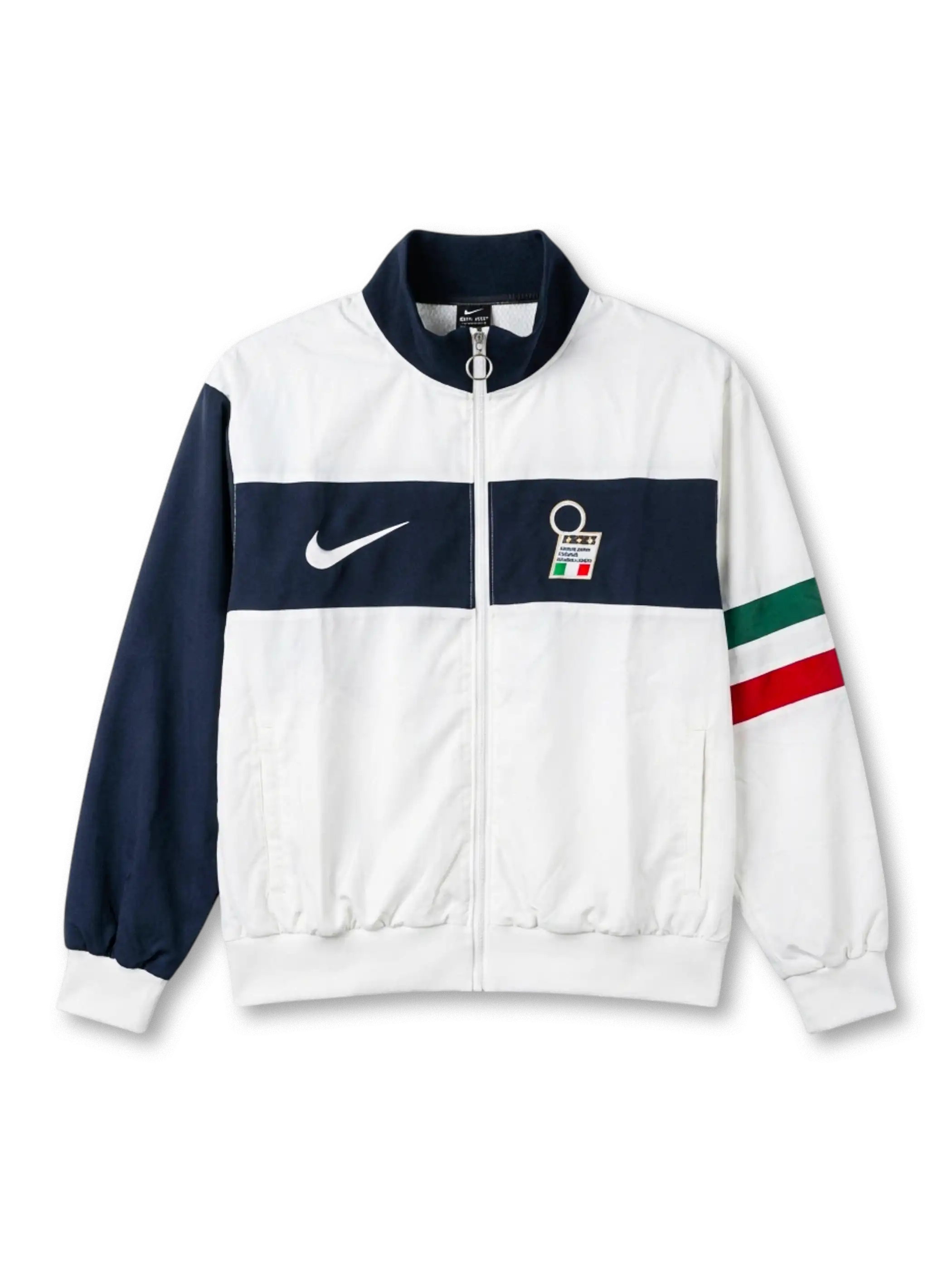 Italy national team Nike track jacket in white with wide navy horizontal chest band, navy stand collar, navy left sleeve, Italian tricolor flag stripe on right sleeve, white Swoosh at left chest, FIGC crest badge at right