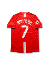 Front view of Manchester United 2008 Champions League Final home shirt in red with AIG sponsor, club crest, Moscow final embroidery, and Champions League sleeve patch.