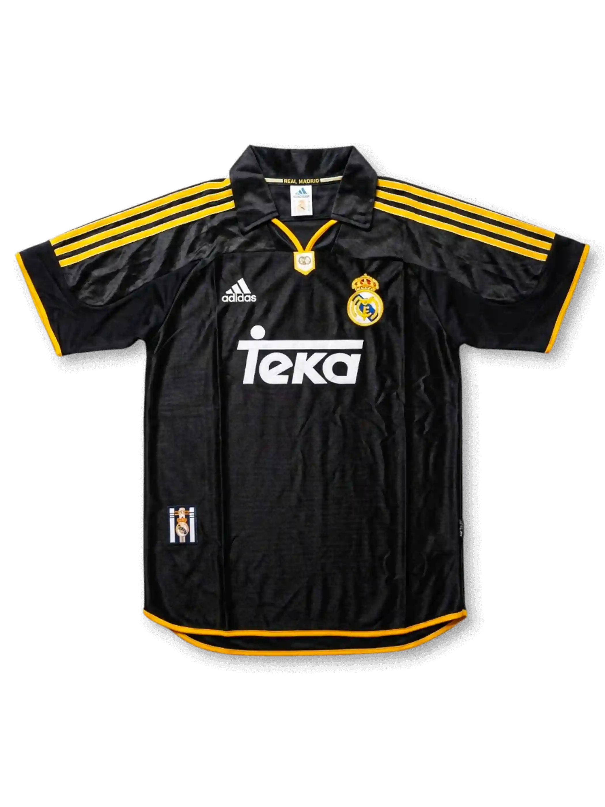 Front view of Real Madrid 1999-2000 away shirt in black with yellow trim, Teka sponsor, adidas logo, club crest, and polo collar.
