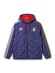 Real Madrid × adidas × Gucci 2022 navy hooded jacket with allover GG, Trefoil, and Real Madrid crest monogram print in gold, Three Stripes on left sleeve, Gucci Web stripe on right, red hood lining visible