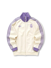 Real Madrid adidas Originals Beckenbauer track jacket in cream with lavender purple Three Stripes, ribbed collar and cuffs, tonal purple Real Madrid crest and Trefoil logo at chest