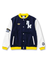 Real Madrid adidas Originals varsity jacket with navy wool body, white leather sleeves, yellow ribbed trim, chenille RM chest patch, gold Trefoil, CE02 sleeve patch, and Real Madrid crest on right sleeve